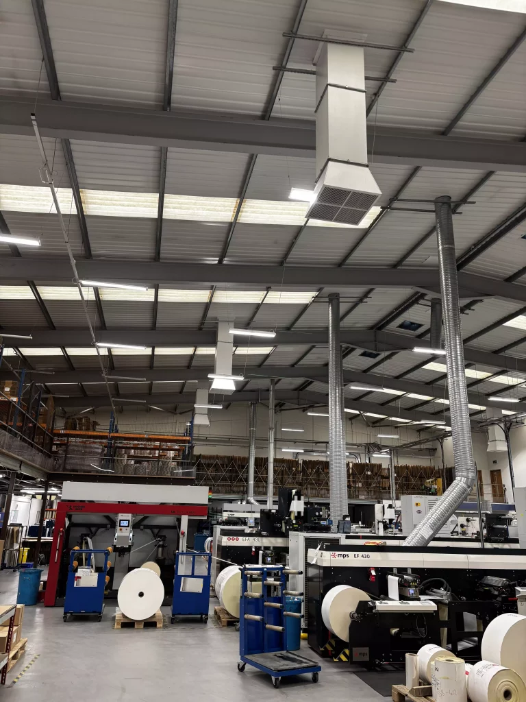 Inside of industrial area with ventilation units showing.